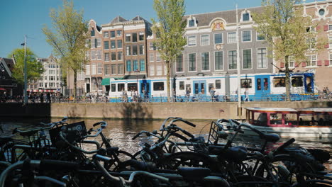 Amsterdam-Canal-With-Bikes-Boat-and-Tram