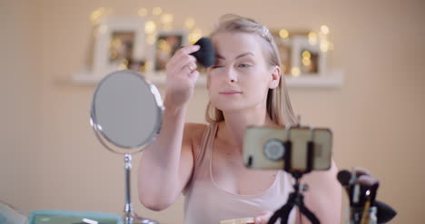 Young-Woman-Doing-Makeup-In-Front-Of-Mirror-At-Home-2