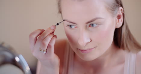 Woman-Doing-Makeup-Painting-Eyelashes-With-Mascara-1