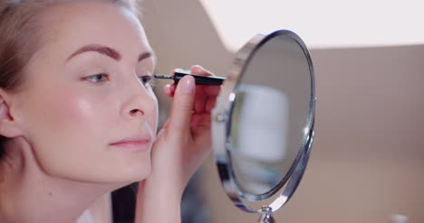 Woman-Doing-Makeup-Painting-Eyelashes-With-Mascara-7