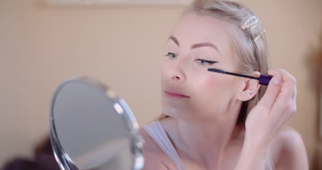 Woman-Doing-Makeup-Painting-Eyelashes-With-Mascara-9