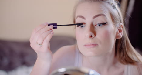 Woman-Doing-Makeup-Painting-Eyelashes-With-Mascara-11