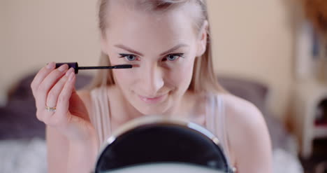 Woman-Doing-Makeup-Painting-Eyelashes-With-Mascara-3
