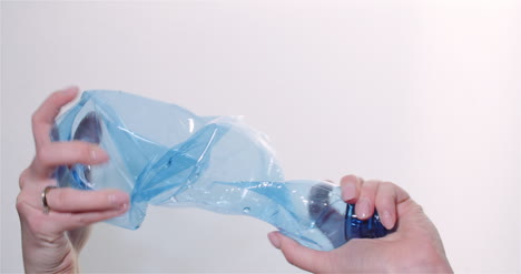 Woman-Squeezing-Plastic-Bottle-In-Hands-Plastic-Recycling-Concept-