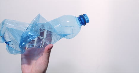 Plastic-Recycling-Woman-Holding-Plastic-Bottle-Waste-In-Hand