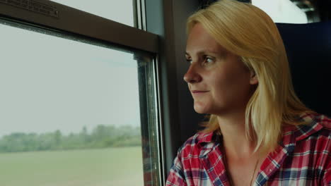 Woman-Looks-out-of-Train-Window