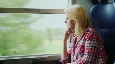 Woman-Looking-out-of-Train-Window