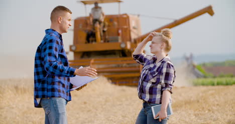 Young-Farmers-Discussing-At-Wheat-Field-2
