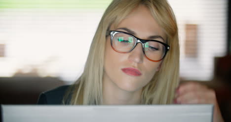 Close-Up-Of-A-Very-Tired-Young-Woman-Working-On-A-Computer-Late-Into-The-Night-
