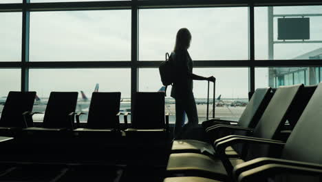 Woman-Watches-Planes-in-Airport