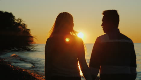 Couple-Walk-on-Beach-at-Sunset
