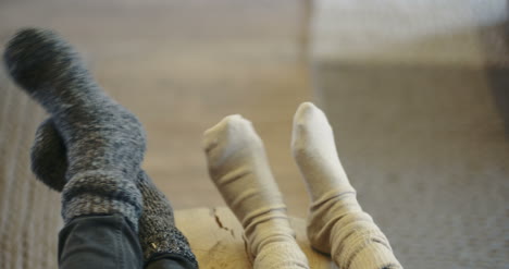 Young-Couple-Wearing-Socks-At-Home