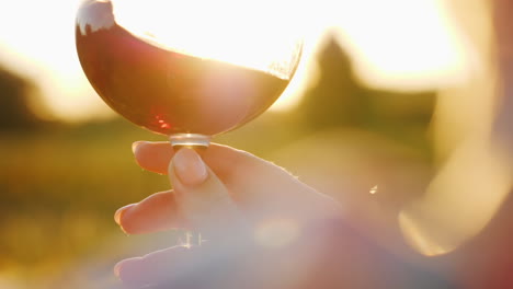 Holding-Wine-Glass-at-Sunset