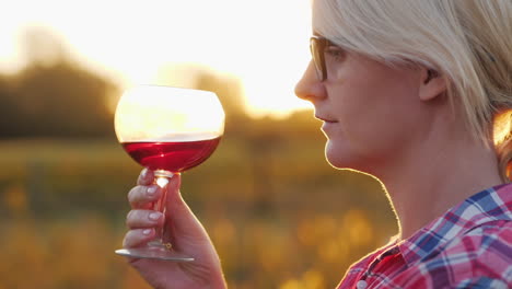 Woman-Tasting-Red-Wine-at-Sunset