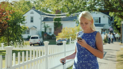 A-Woman-Using-A-Smartphone-in-Suburb