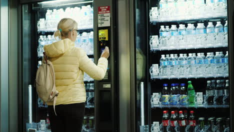 Woman-Buys-Soda-From-Vending-Machine