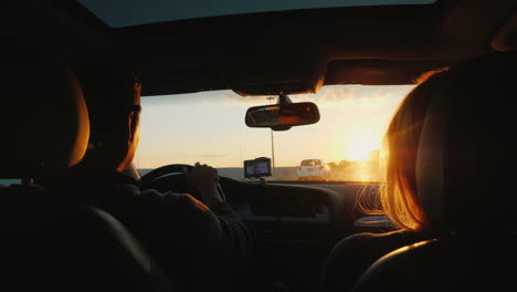 Couple-Drive-on-Highway-at-Sunset