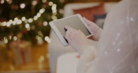 Woman-Using-Digital-Tablet-And-Shopping-Online-During-Christmas-9
