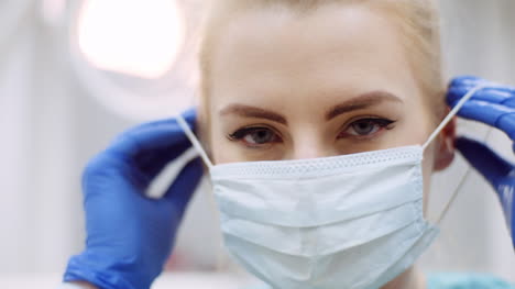 Dentist-Putting-On-Protective-Mask-Before-Surgery-4