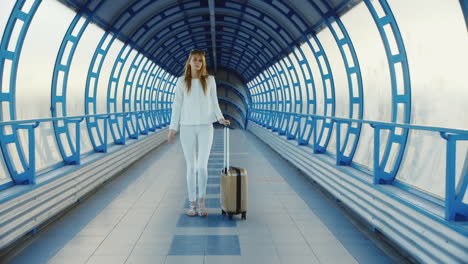 Young-Business-Woman-With-Travel-Bag-On-Wheels-Is-On-The-Transition-From-The-Terminal-At-The-Airport