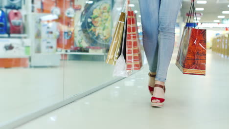 Woman's-Legs-In-Fashionable-Shoes-On-A-High-Platform-Go-To-The-Mall-It-Carries-A-Lot-Of-Packages-For