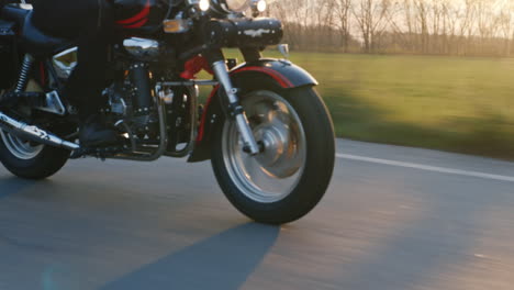 Motorcycle-Wheels-Which-Quickly-Goes-On-The-Road-The-Sun-Shines-And-Gives-A-Nice-Glare-Hd-Video