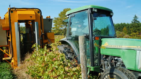 Farmer-Pulls-Mechanical-Grape-Harvester-With-Tractor