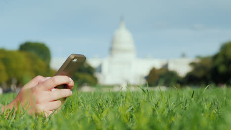 Hands-Use-Phone-By-Capitol-Building