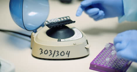 Scientist-Puts-Virus-Samples-Into-Machine-At-Biotechnology-Molecular-Laboratory-