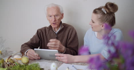 Granddaughter-With-Grandfather-Using-Digital-Tablet-4