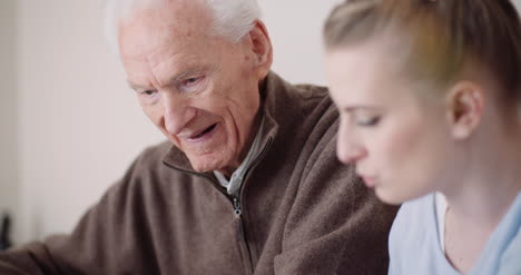 Old-Man-Retirement-Smiling-Senior-Man-Talking-With-Granddaughter