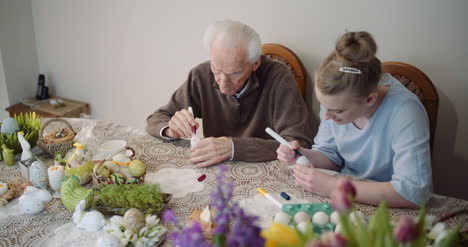 Senior-Man-And-Woman-Painting-Easter-Eggs