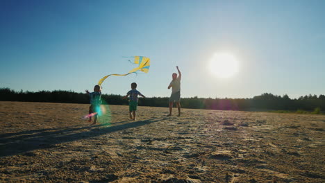 Young-Father-Playing-With-His-Two-Sons-Flying-A-Kite