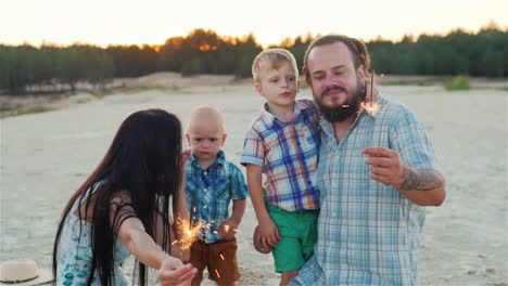 Happy-Family-Playing-With-Children---Burning-Sparklers