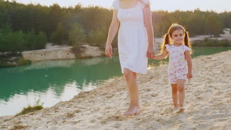Mother-And-Daughter-Walking-On-The-Beach-At-The-Beautiful-Lake-With-Azure-Water-My-Mother-Is-A-Girl'