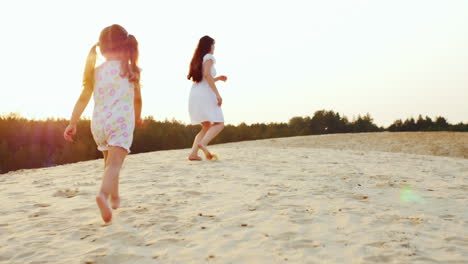 Mom-Plays-With-A-Girl-Three-Years-The-Girl-Runs-After-Her-Mother-On-The-Sand-Happy-Childhood