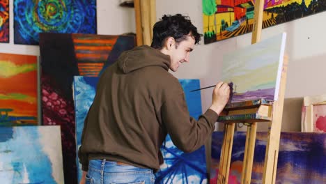 Working-In-The-Creative-Studio-Of-The-Painter-Young-Mixed-Race-Artist-Paints-A-Picture