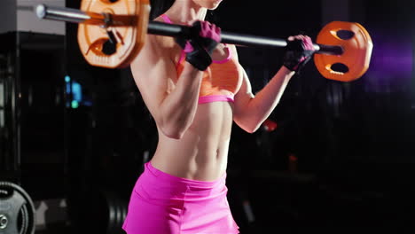 Athletic-Woman-Trains-Muscles-Of-The-Hands-With-A-Barbell-Female-Bodybuilding
