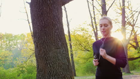 An-Attractive-Young-Woman-Makes-A-Morning-Jog-In-The-Forest-The-Sun-Is-Shining-Beautifully-And-Gives