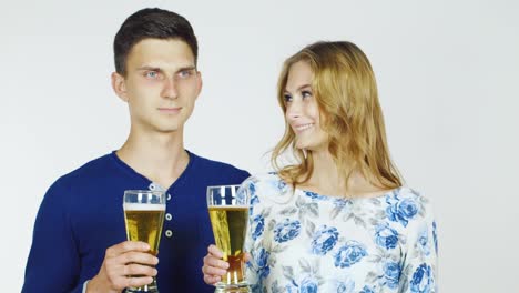 Man-And-Woman-With-Beer-Glasses-On-A-White-Background-Hd-Video
