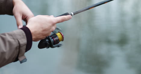 Fisherman-Holding-Fishing-Rod-In-Hands-2