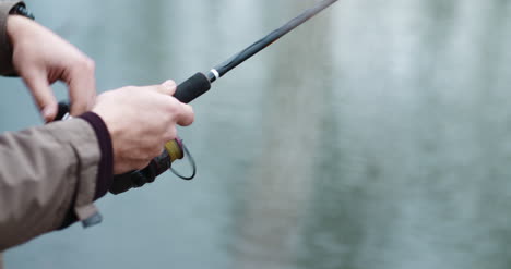 Fisherman-Holding-Fishing-Rod-In-Hands-3