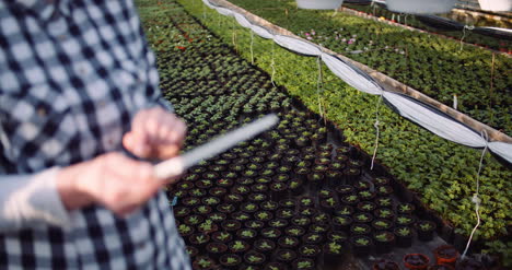 Gardener-Using-Digital-Tablet-At-Greenhouse-1