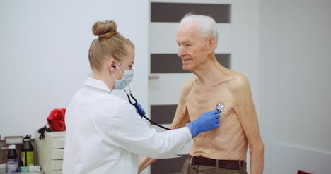 Female-Doctor-Examine-Elderly-Man-With-Stethoscope