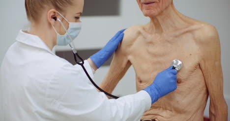 Female-Doctor-Examine-Elderly-Man-With-Stethoscope-1