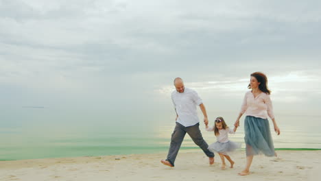 Happy-Family-Of-Three-People-Running-On-The-Beach-01