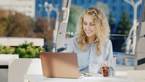 Young-Business-Woman-Working-In-A-Cafe-With-A-Laptop-Eat-Ice-Cream-On-The-Summer-Terrace-Of-A-Cafe