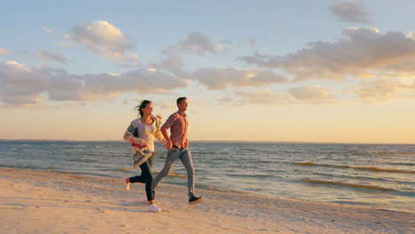 Young-Couple-Running-Along-The-Seashore-At-Sunset-The-Concept---A-Happy-Honeymoon-The-Energy-Of-Yout