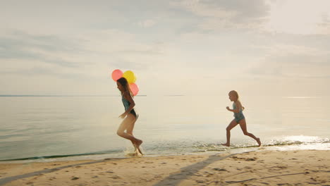 Happy-Childhood---Two-Sisters-Running-Around-Each-Other-On-The-Beach-Have-Fun-Steadicam-Slow-Motion-