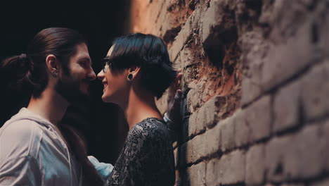 Young-Gothic-Hipster-Couple-Admiring-Each-Other-On-The-Background-Of-Brick-Wall